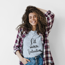 Load image into Gallery viewer, Woman wearing a plaid shirt over a t-shirt with 'Lit with Intention' text, smiling against a white background
