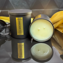 Load image into Gallery viewer, Premium Linen Daze soy candle set with both lid on and off views, placed on a reflective surface to highlight the sleek design and triple wick detail.