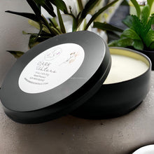 Load image into Gallery viewer, Matte black travel tin candle with ocean-inspired musk scent