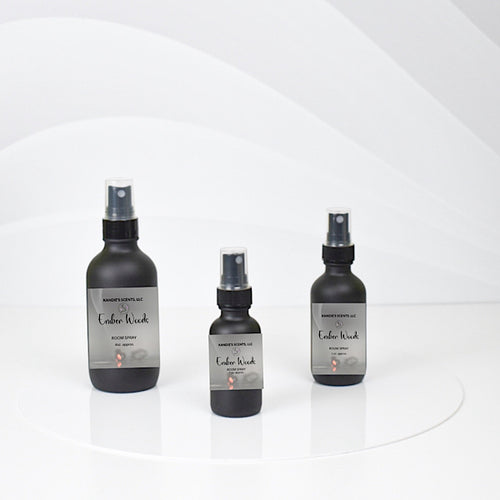Ember Woods room spray bottles with citrus and earthy notes