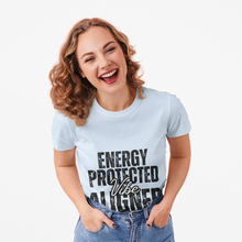Load image into Gallery viewer, Woman wearing a light blue t-shirt with 'Energy Protected Vibe Aligned' text smiling against a white background
