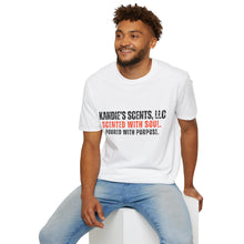 Load image into Gallery viewer, Man wearing a white t-shirt with 'Kandie's Scent, LLC- Scented with Soul. Poured with Purpose.' printed on it, sitting on a white stool against a white background.

