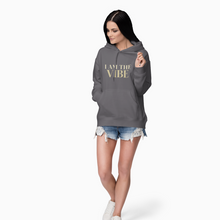 Load image into Gallery viewer, Woman wearing a gray hoodie with 'I AM THE VIBE' text on a white background
