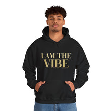 Load image into Gallery viewer, Person wearing a black hoodie with 'I AM THE VIBE' text on a white background
