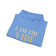 Load image into Gallery viewer, Folded blue hoodie with 'I AM THE VIBE' text on a white background
