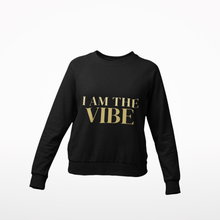 Load image into Gallery viewer, Black sweatshirt with 'I AM THE VIBE' text in gold on a white background
