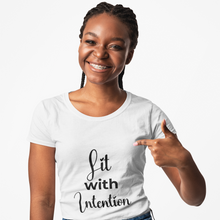 Load image into Gallery viewer, Woman wearing a white t-shirt with 'Lit with Intention' text, pointing to the text.
