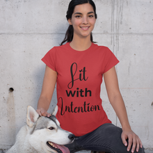 Load image into Gallery viewer, Woman wearing a red t-shirt with 'Lit with Intention' text, sitting next to a dog against a concrete wall.
