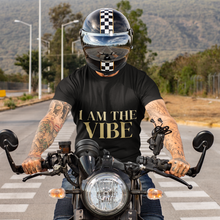 Load image into Gallery viewer, Person on a motorcycle wearing a black t-shirt with 'I AM THE VIBE' text, checkered helmet.
