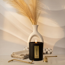 Load image into Gallery viewer, Candle with a decorative vase and pampas grass on a neutral background
