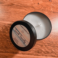 Matte black tin candle with coastal floral fragrance